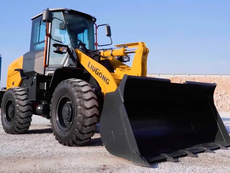 Cargador LiuGong 835T en operación con el cucharón elevado en banco de material